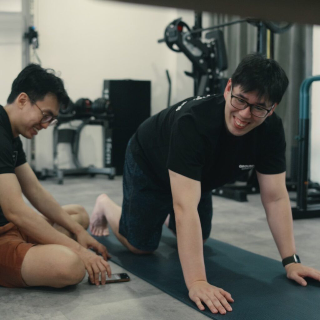 A man performing a bear crawl exercise to develop functional neck stability and shoulder integration, transitioning bodyweight loads through the cervical spine.