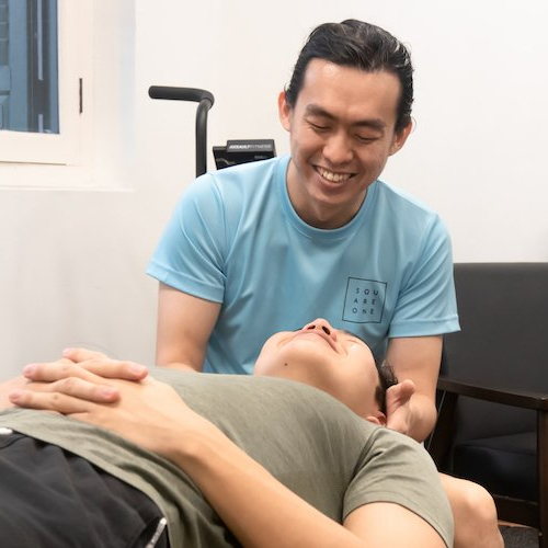 Jesse Cai, a chiropractor, performing passive cervical spine manual adjustments on a patient to demonstrate temporary symptom management.