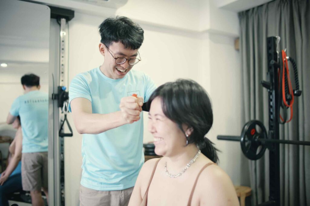 Chiropractor Jesse Cai using a digital dynamometer to measure cervical spine muscle strength. Rehab programme is based on objective neck data at Square One Active Recovery.