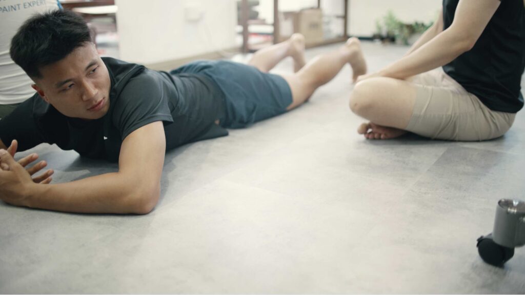 A person performing extension movements to centralise spinal disc pain.