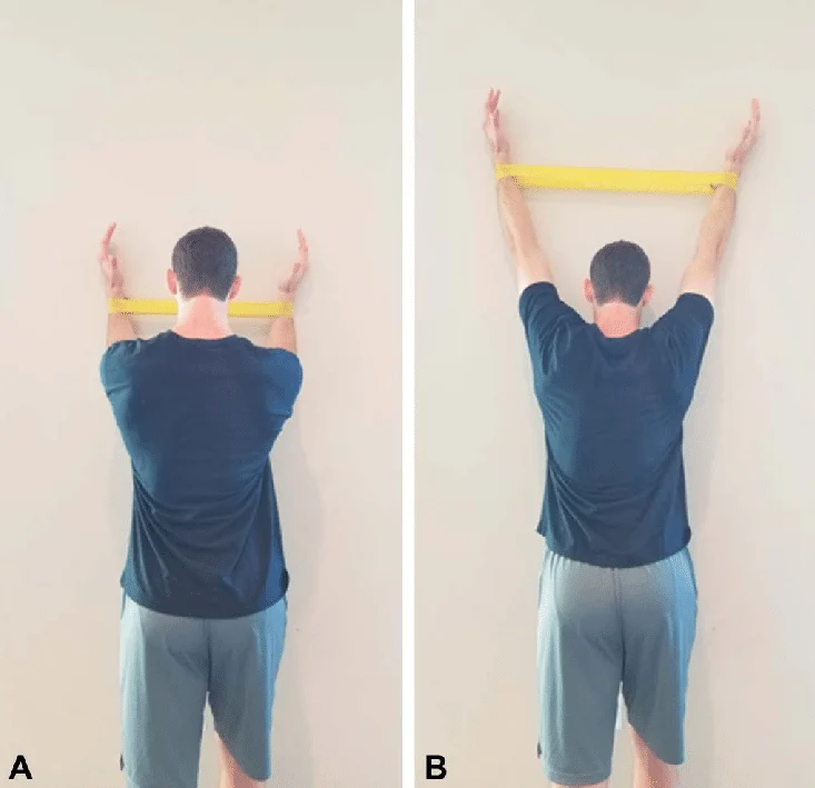 Demonstration of forearm wall slides with a resistance band for shoulder joint centration.