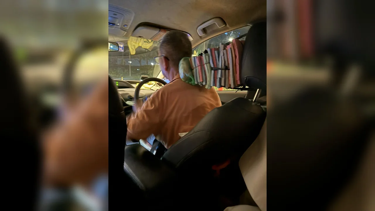 Singapore taxi driver's custom car seat setup using bundles of joss paper for ergonomic back support.